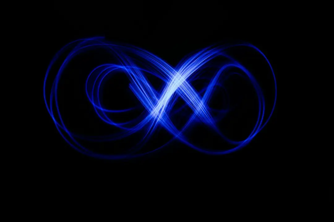 Blue light trails forming an infinity loop on a black background, a picture of the XerquvaTV IPTV streaming service